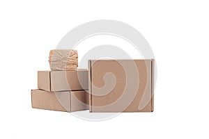 Stack of craft paper boxes and coil of rope isolated on white