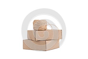 Stack of craft paper boxes and coil of rope isolated on white