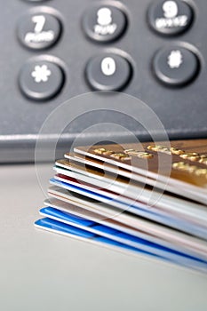 Stack of Credit cards and telephone in background