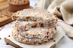 Stack of crunchy buckwheat cakes on wooden table, closeup