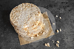 Stack of crunchy rice cakes on grey background.