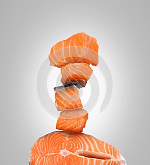 Stack of cut fresh salmon on light grey background