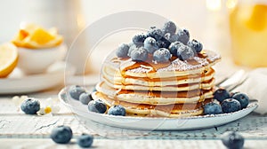 Stack of delicious fluffy homemade pancakes with fresh blueberries and honey or maple syrup on a plate. Traditional American