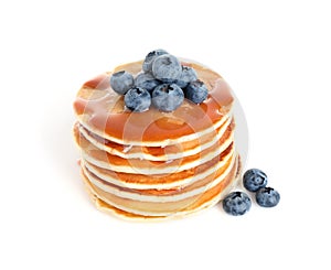 Stack of delicious pancakes with fresh blueberries and syrup