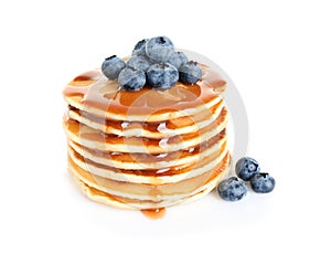 Stack of delicious pancakes with fresh blueberries and syrup