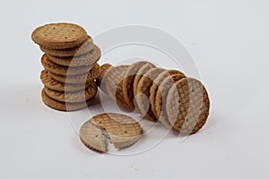 A stack of delicious wheat round biscuits with a few crumbs