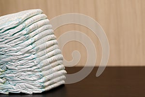 Stack of diapers or nappies on table, copyspace