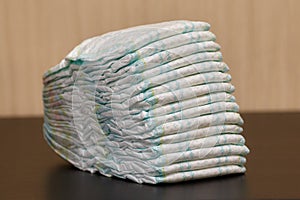 Stack of diapers or nappies on table, copyspace