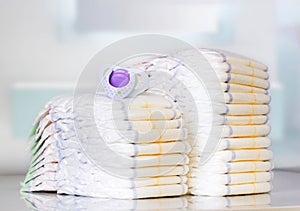 Stack of diapers on table indoors.