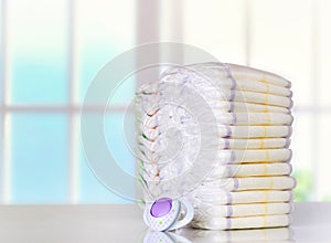 Stack of diapers on table indoors.