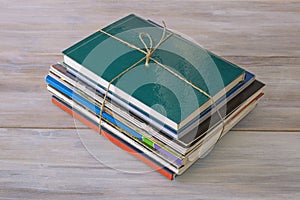 Stack of different books and magazines on table