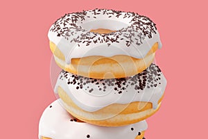 Stack of different chocolate glazed donut with sprinkles on a pink background