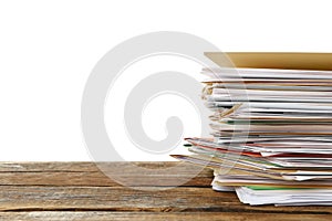 Stack of different files with documents on wooden table against white background. Space for text