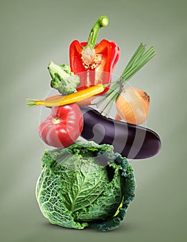 Stack of different fresh vegetables on green grey background