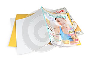 Stack of different magazines on white