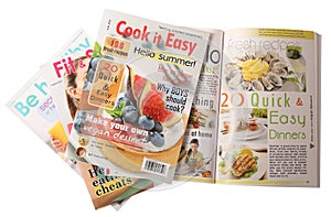 Stack of different magazines on white, top view