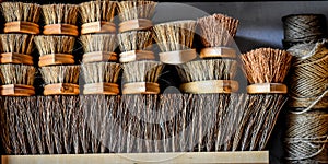 Stack of Wooden Bristle Brushes and Twine photo
