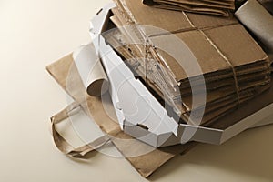 Stack of different waste paper on beige background, closeup