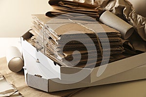 Stack of different waste paper on beige background, closeup