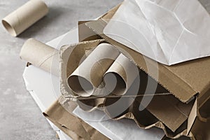 Stack of different waste paper on grey table, closeup