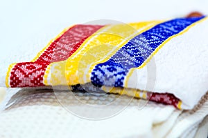 Stack of dish towels with Romanian motives of tricolor. Kitchen