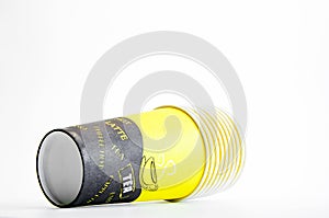 A stack of disposable glasses. Coffee. Multi-colored paper. Close up on a white background