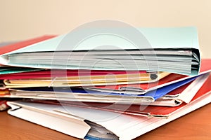 Stack of document file folders on the brown wooden desk