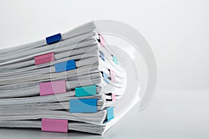 Stack of documents with binder clips on light table. Space for text