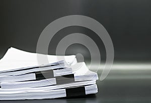 Stack documents or files on black background.