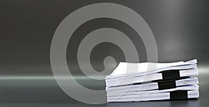 Stack documents or files on black background.