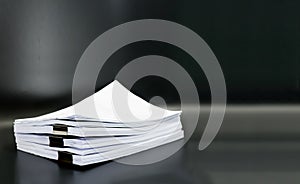 Stack documents or files on black background.