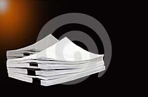 Stack documents or files on black background.