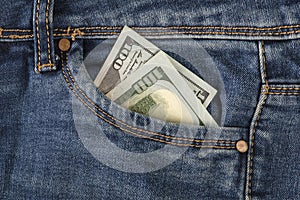 Stack of 100 dollar bills in jeans pocket. Money in the front pocket of jeans. The concept of investment, cash, wealth
