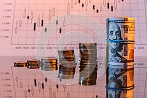 Stack Dollars  and coins at glossy surface