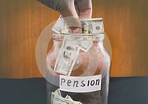 Stack dollars in a glass jar. Saving money. Pension concept.