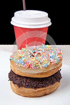 Stack of Donuts and coffee in white plate with black background