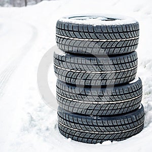 Stack of winter tires isolated on white background