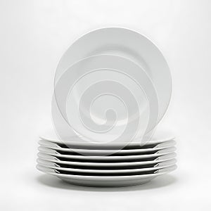 Stack of elegant white dinner plates isolated on white background