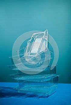 Stack of empty polystyrene plastic containters on blue