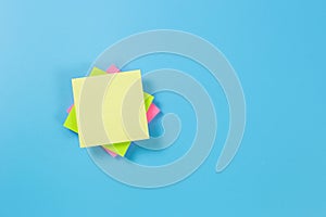 Stack empty sticky post note paper sheet on blue background