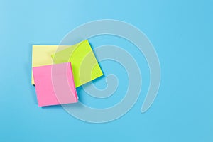 Stack empty sticky post note paper sheet on blue background