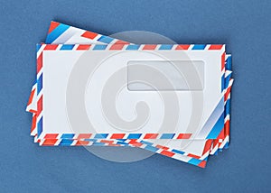 A stack of envelopes on a blue