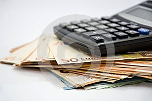 Stack with euro banknotes and a calculator. Close-up. Financial concept. Savings concept