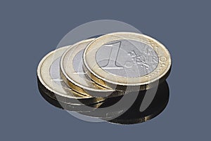 Stack of euro coins on gray background