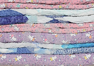 Stack of Faded, Worn Children's Quilts