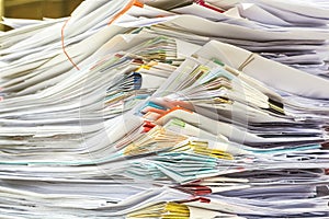 Stack of files full of documents signifying photo