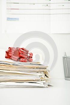 Stack of Files Topped By a Gift Bow