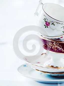 Stack of fine porcelain tea cups and saucers photo