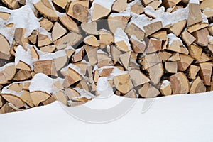 Stack of firewood and snow