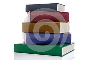 Stack of five hardback books isolated on white photo